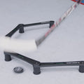 a hockey player stickhandling and passing a puck through the gates of an electronic stickhandling tool